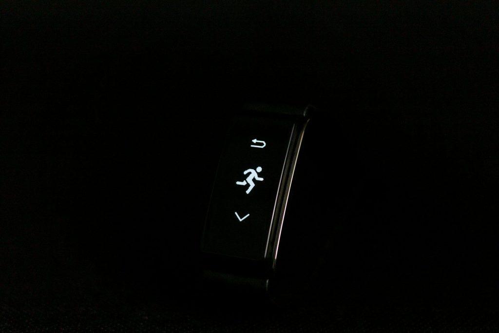 a close up of a watch on a black surface
